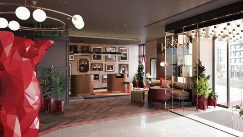 a lobby of a hotel with plants in a room at Radisson RED Berlin Kudamm in Berlin