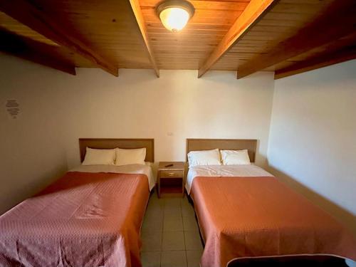 a room with two beds in a room at Hotel towi in Creel
