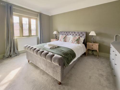 a bedroom with a large bed and two windows at Grange Garth near the river in York