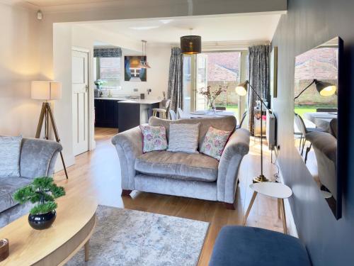 a living room with a couch and a table at Grange Garth near the river in York