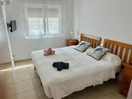een slaapkamer met een bed met twee handdoeken erop bij Apartamento Es Calo (Edificio Cavall de Llevant) in Es Calo