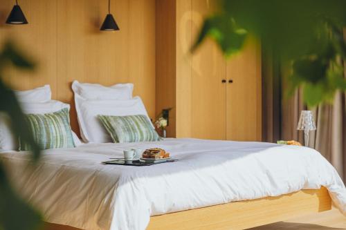 a bed with a plate of food on it at Le Bois d’Alice in Chanoz-Châtenay
