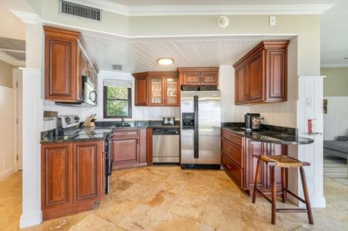 a kitchen with wooden cabinets and a refrigerator at George Town Villas 118 in George Town