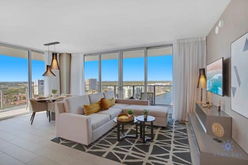 a living room with a couch and a table at High Floor with Stunning Views, Amazing Pools in Hollywood