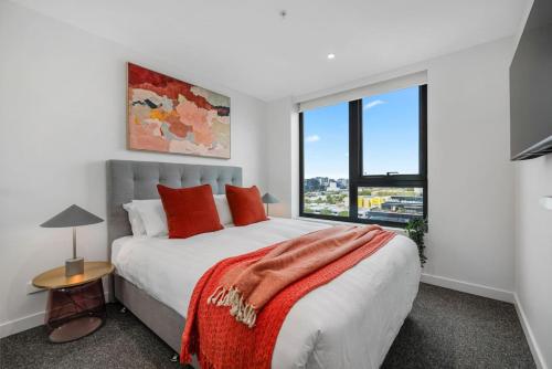 a bedroom with a large bed and a large window at Urban Elegance Stature Southbank in Melbourne