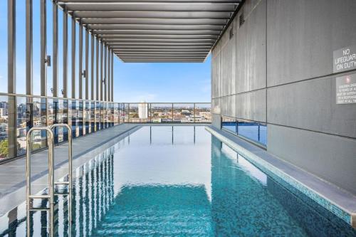 a swimming pool in the middle of a building at Urban Elegance Stature Southbank in Melbourne
