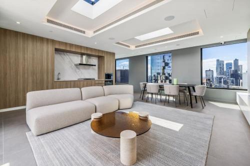 a living room with a couch and a table at Urban Elegance Stature Southbank in Melbourne