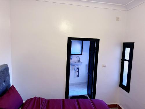 a bathroom with a mirror and a sink in a room at Dar Noureddine in Lalla Takerkoust