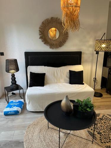 une chambre avec un lit avec une table et un miroir dans l'établissement studio Lauralex, à Montardon