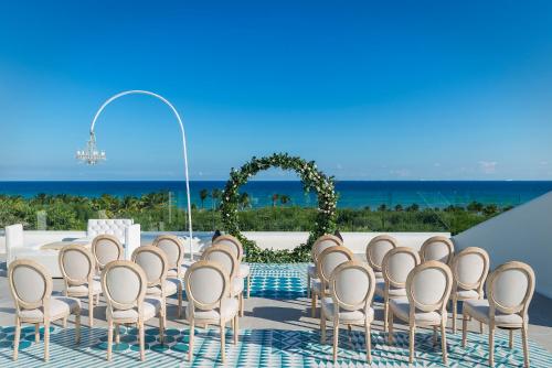 a set up for a wedding ceremony with an arch and chairs at Ocean Riviera Paradise All Inclusive in Playa del Carmen