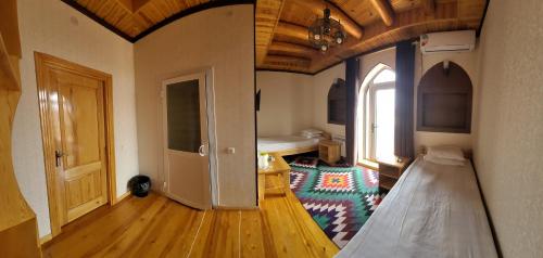 a room with a bedroom with a bed and a door at Khiva Siyovush Hotel in Khiva
