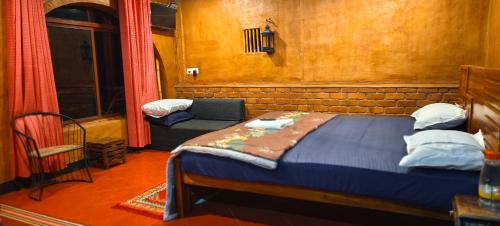 a bedroom with a bed and a chair in a room at ANGELSNESTMOUNTAINVIEW in Chekadi