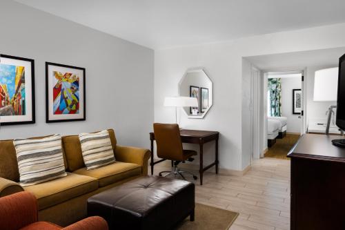 a living room with a couch and a desk at Hampton Inn & Suites San Juan in San Juan