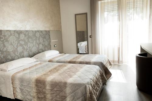 Postel nebo postele na pokoji v ubytování Hotel Casa Tra Noi