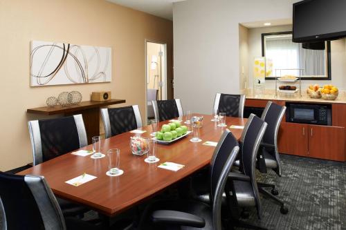 a conference room with a wooden table and chairs at Courtyard Columbus Dublin in Dublin