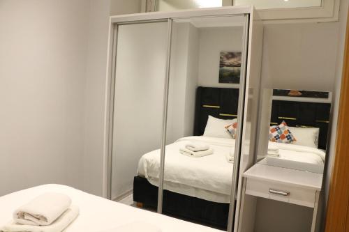 a small bedroom with a mirror and a bed at The Most Hotel in Istanbul