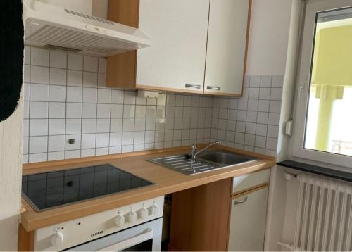 a small kitchen with a sink and a stove at Privatzimmer nähe Residenz und Innenstadt in Würzburg
