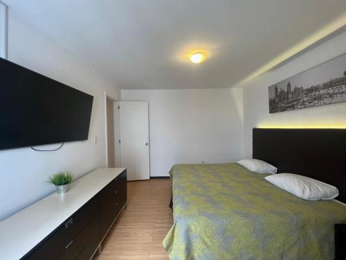 Voodi või voodid majutusasutuse Suites Havre toas