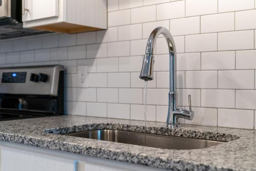 a kitchen sink with a faucet on a counter at Cozy 2Bed Boho Hideaway 10 Min to Parks Allows Pet in Orlando