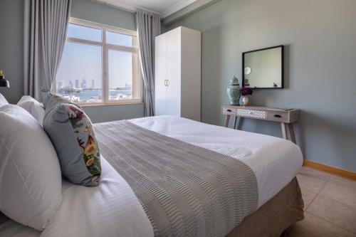 a bedroom with a large bed with a window at Frank Porter - Al Haseer in Dubai