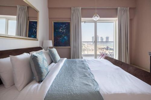 a bedroom with a large bed with a large window at Frank Porter - Emirates Crown Tower in Dubai