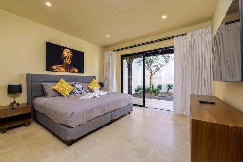 a bedroom with a large bed and a large window at Spacious New 3BR Villa at Copala-Quivira in Cabo San Lucas