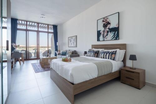 a bedroom with a large bed and a living room at Frank Porter - Palm Views East in Dubai