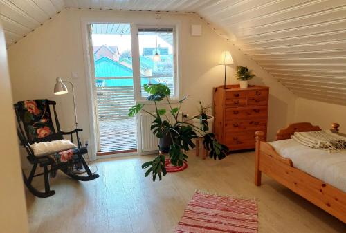 a bedroom with a bed and a chair and a window at Nice holiday accommodation in picturesque Bralanda outside Vanersborg in Brålanda