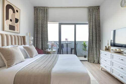 - une chambre avec un grand lit et une télévision dans l'établissement Frank Porter - Azizi Aura, à Dubaï
