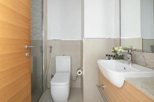 a bathroom with a toilet and a sink at Frank Porter - Azizi Aura in Dubai