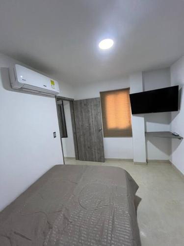 a room with a bed and a window in it at Apto 301 cerca a C.C. unicentro in Cúcuta