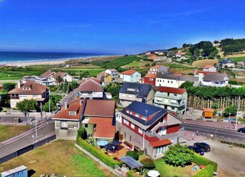 an aerial view of a town with houses and the ocean at Piso Don Ramón in Razo