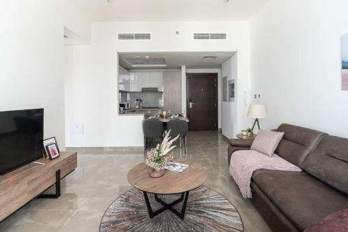 a living room with a couch and a table at Frank Porter - Majestique Residence 2 in Dubai