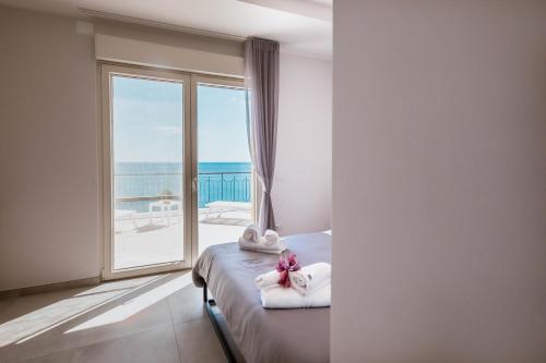 a bedroom with a bed with a view of the ocean at BLU MARINE in Catanzaro