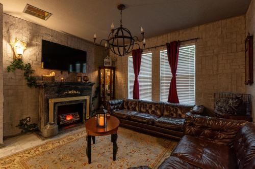 a living room with leather furniture and a fireplace at Stay at Hogwarts Harry Potter's Home, Free Parking, Pets Allowed in Kissimmee