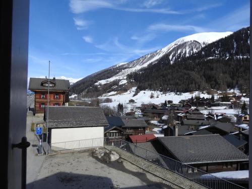 a view of a town with a snow covered mountain at Casa Mia Goms in Reckingen - Gluringen