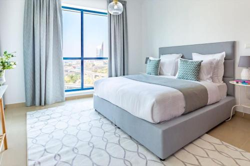a bedroom with a large bed and a large window at Frank Porter - X1 Tower in Dubai