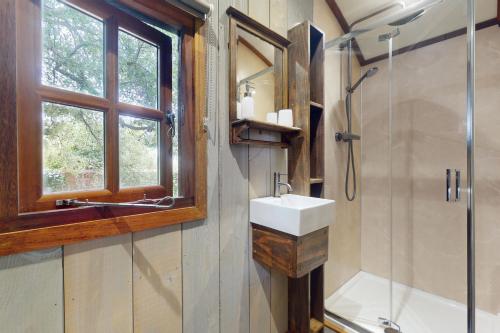 a bathroom with a sink and a shower at The Woodmans Hut Minehead in Minehead
