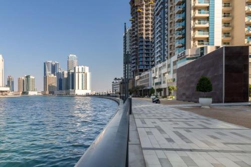 a city street with a body of water and buildings at Frank Porter - Mayfair Residency in Dubai
