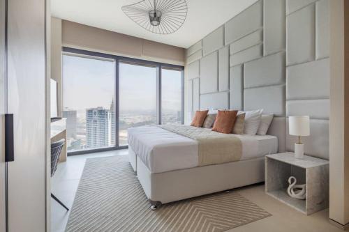 a bedroom with a large bed and a large window at Frank Porter - The Address JBR in Dubai