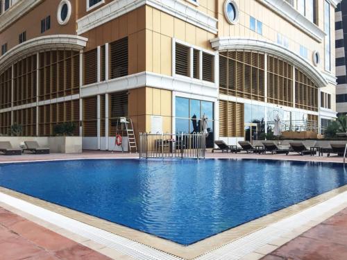 a large swimming pool in front of a building at Frank Porter - Elite Residence in Dubai