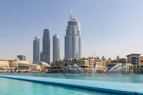 a view of a city with a fountain and buildings at Frank Porter - The Lofts in Dubai