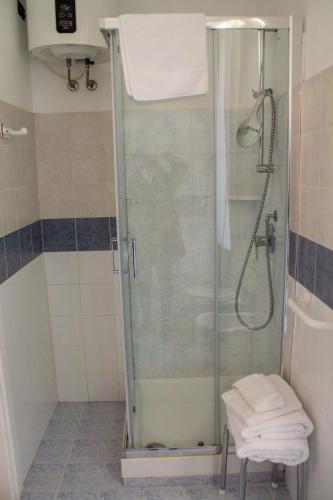 a shower with a glass door in a bathroom at Villa Belvedere in Pieve Fosciana