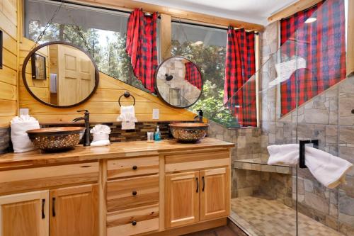 a bathroom with two sinks and a shower at Fox Lodge Big Bear-Indoor Pool-Hot Tub-Games-Luxury Retreat in Big Bear City