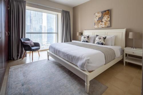 a bedroom with a large bed and a window at Frank Porter - Marina Tower in Dubai
