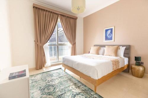 a bedroom with a bed and a large window at Frank Porter - Mon Reve in Dubai