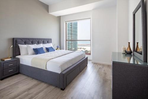 a bedroom with a large bed and a large window at Frank Porter - Shams 4 in Dubai