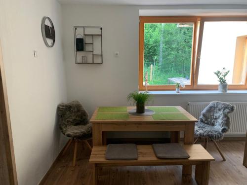 a room with a table and two chairs and a window at Črjanski Raj in Črna na Koroškem