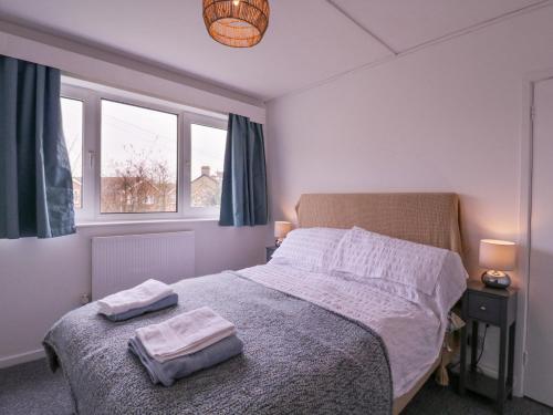 a bedroom with a bed with two towels on it at The Upper Circle in Clacton-on-Sea