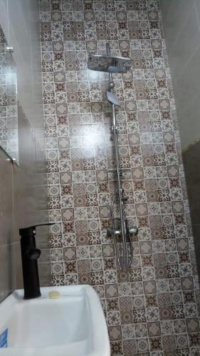 a shower in the corner of a bathroom with a sink at Villa isouktan in Sbiti